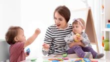 Nanny playing with two children.